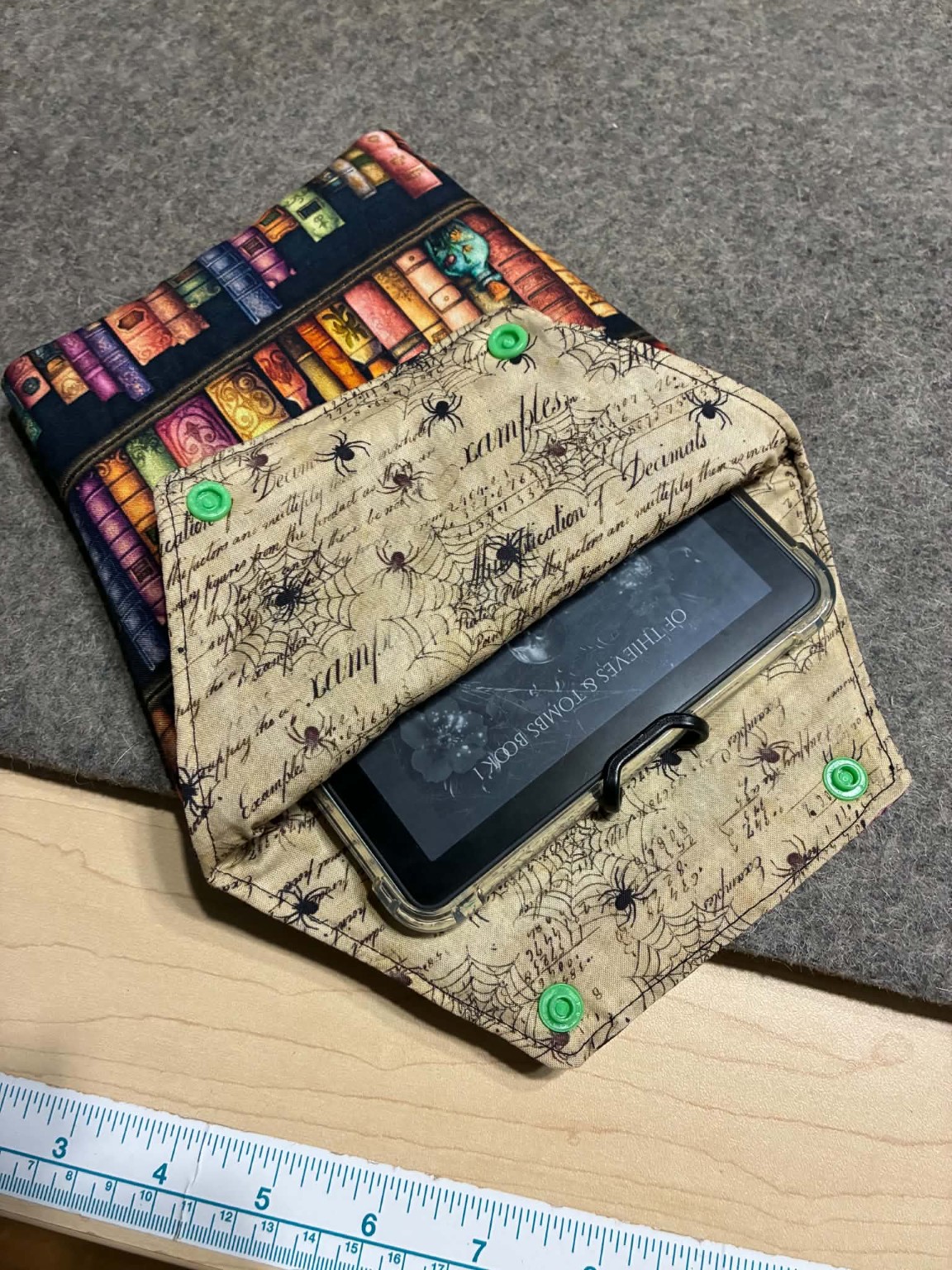 Handmade coffin-shaped Kindle sleeve open to show spiderweb lining