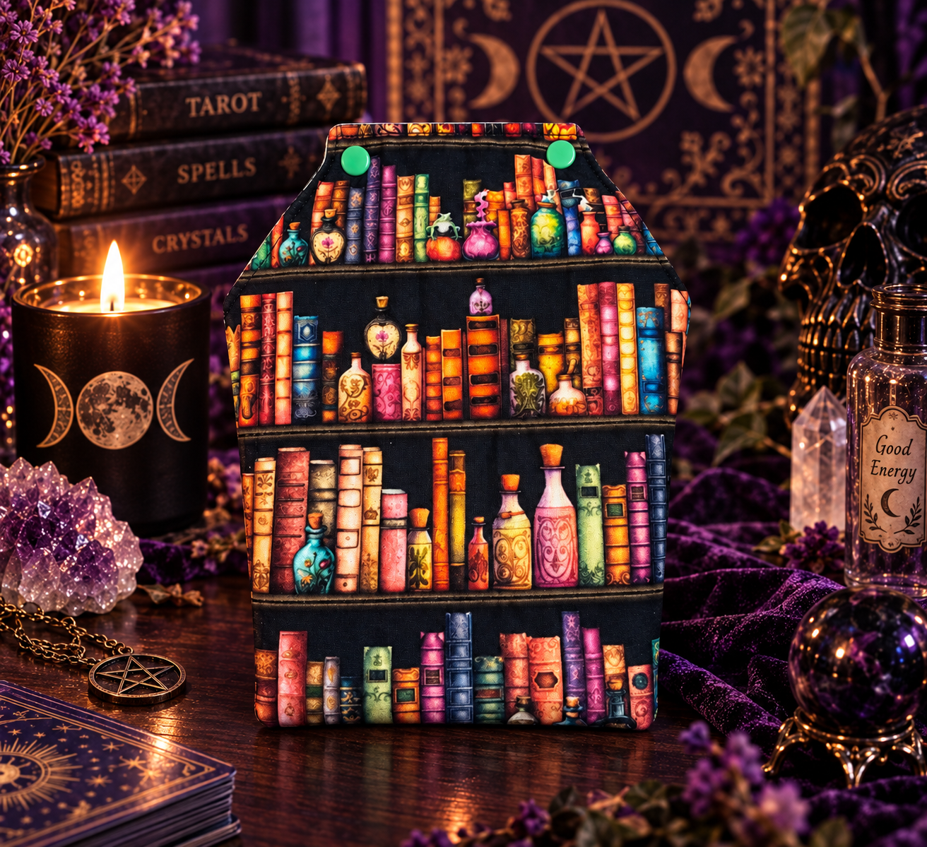 Handmade coffin-shaped Kindle sleeve in a richly styled purple bookish setting
